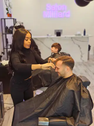 Sophia styling a client at the salon